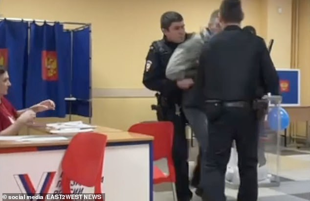 Two police officers eventually took the voter away before a female poll official intervened to tell police that the man had the right to mark his ballot however he wanted.