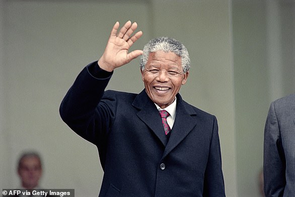 Pictured: Nelson Mandela, South African anti-apartheid leader and member of the African National Congress (ANC), greets the press as he arrives at the Elysée, June 7, 1990.