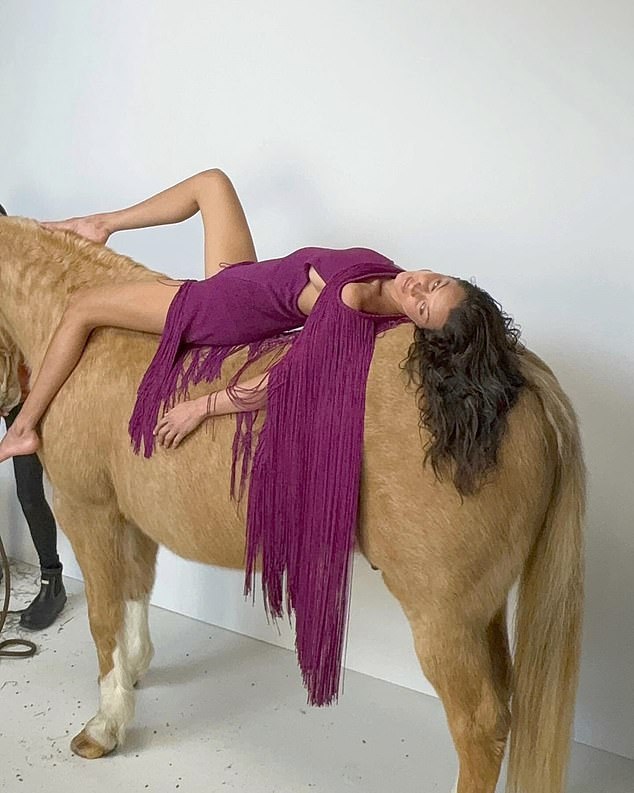Hold your horses, Bella Hadid!  The model was slammed yesterday for lying down and standing on a horse during her latest photo shoot for Vogue Italia.
