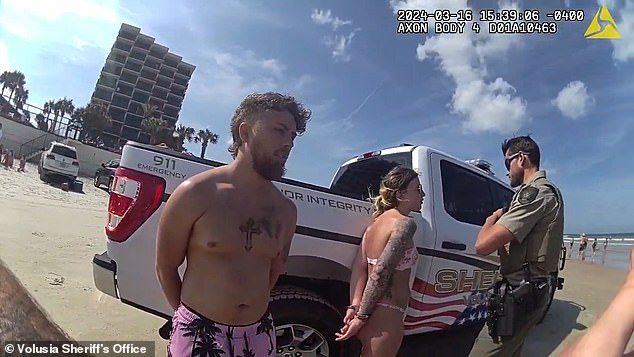 The couple are seen handcuffed on the beach by the officer before Stephens runs off.