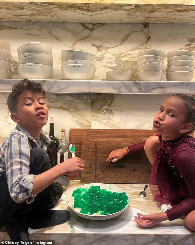 Chrissy's oldest children, Luna, seven, and Miles, five, appeared in several snaps, including a silly one in which they sat on the granite countertop while eating from a plate of green jelly.