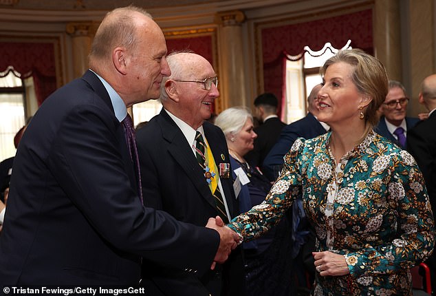 The mother-of-two appeared in good spirits as she shook hands with veterans at the event at Buckingham Palace.