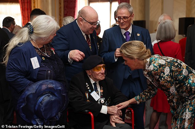 Sophie welcomed Korean War veteran Roger Baker (pictured centre) on behalf of King Charles