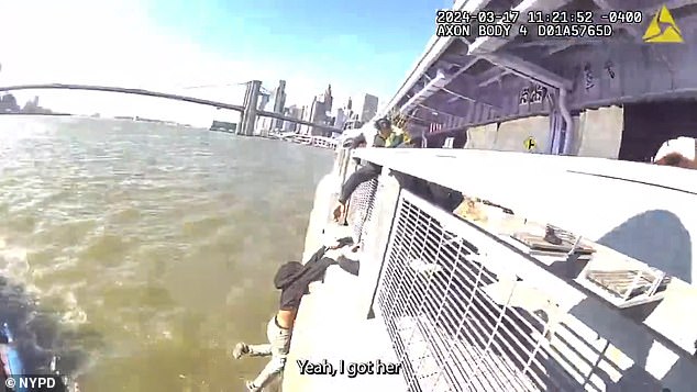 Dramatic police body camera footage recorded images of the woman suspended just inches above the fast-flowing river.