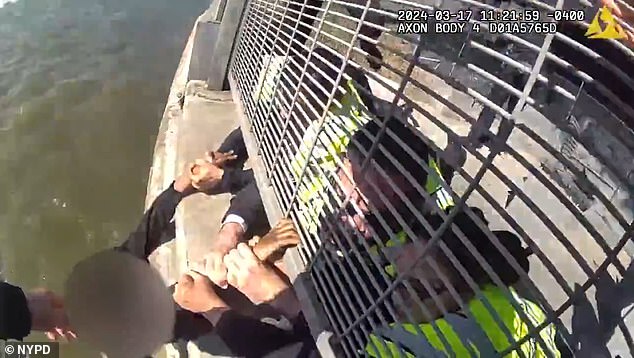 Three officers held the woman's wrists when the harbor police boat arrived below.