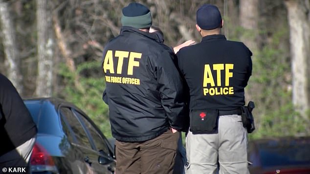 An ATF agent was shot and killed in an exchange of gunfire, but his life is not in danger, officials said. Officers are seen outside the home Tuesday