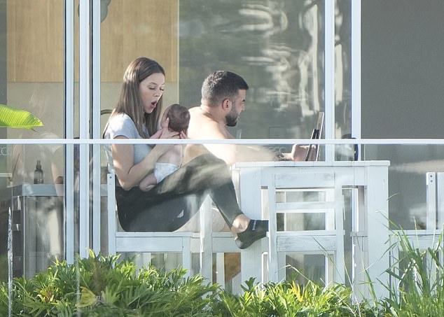 The controversial bidder was seen relaxing with his beautiful partner Karlie on a white bench, as she lovingly doted on their baby.