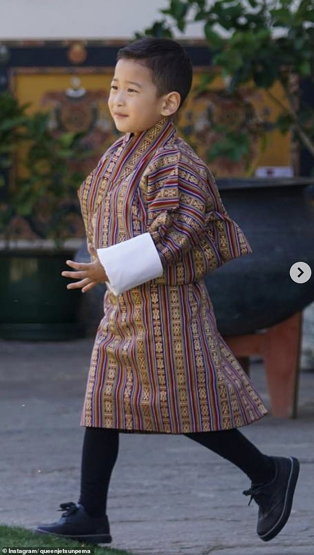 In the second image, the young royal sported a beaming smile as he played outside in traditional attire.