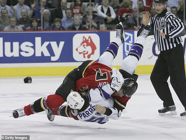 George Parros is knocked down during a fight with Simon during a game in Calgary in 2006