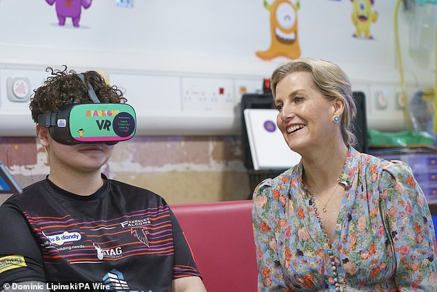 Sophie (pictured, right) is seen learning high-tech virtual reality processing, as demonstrated by Brayden McGibbon (pictured, left).