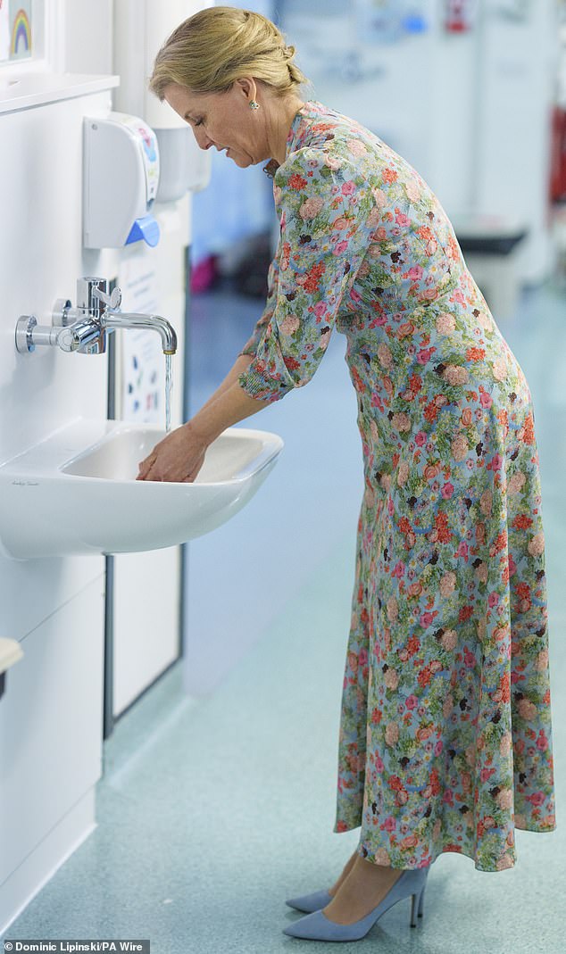 KEEPING IT CLEAN: The royal is pictured washing her hands as she enters the sterile hospital environment