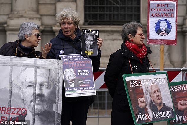 Some demonstrators outside the municipality building in Milan, Italy, are protesting the extradition of Julian Assange earlier this month.