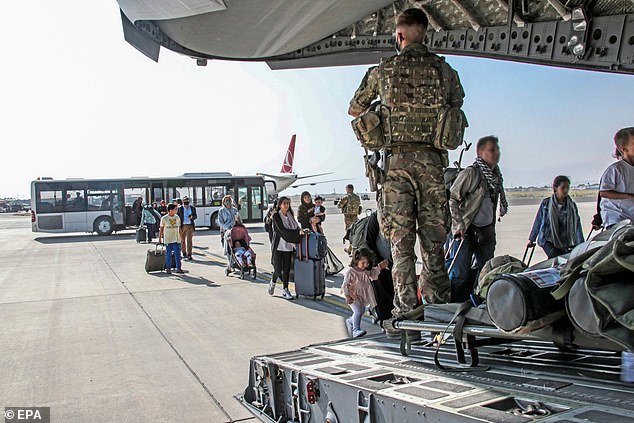 British citizens and dual nationals board a military plane at Kabul airport, Afghanistan.