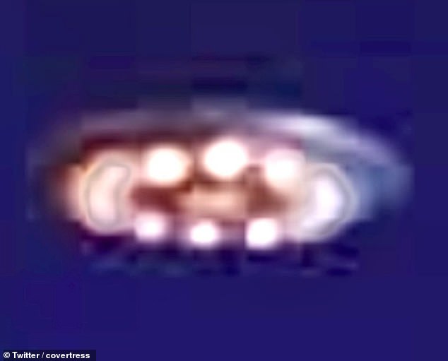 An image shows a saucer-shaped craft with glowing lights surrounding the base