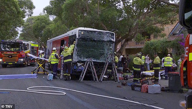 A bus driver and a female passenger were trapped inside one of the vehicles, forcing firefighters to smash the front windshield (pictured) to save the two men.