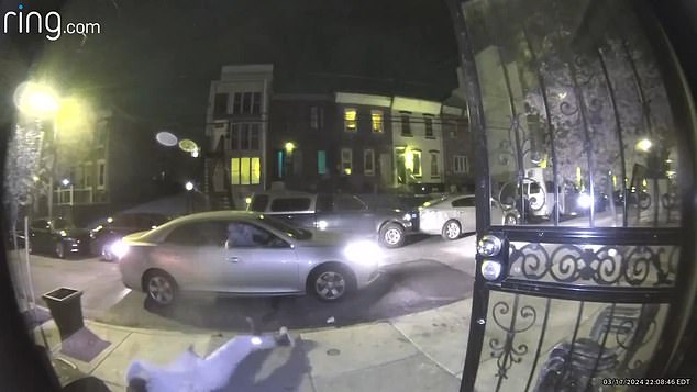 Gant falls backwards as shots ring out – with the person inside the car firing 12 shots at him as he hits the curb