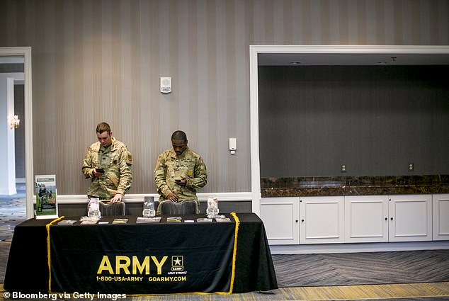 Army leaders have spoken of difficulties in recruiting recruits, leading to a shortage of 15,000 troops last year. Pictured: Army recruiters at a Michigan job fair