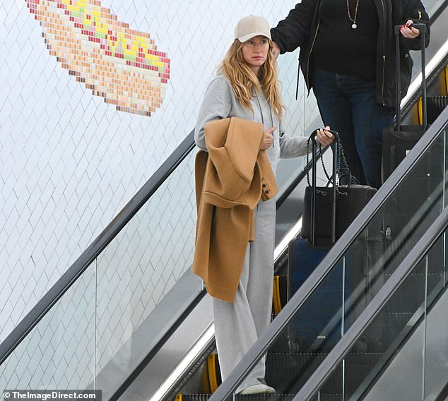 The star wore a gray hoodie along with matching sweatpants to stay comfortable during her busy travel day.