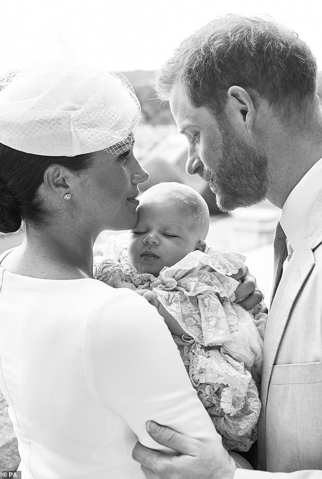 This official christening photograph released by the Duke and Duchess of Sussex shows the couple with their son, Archie.
