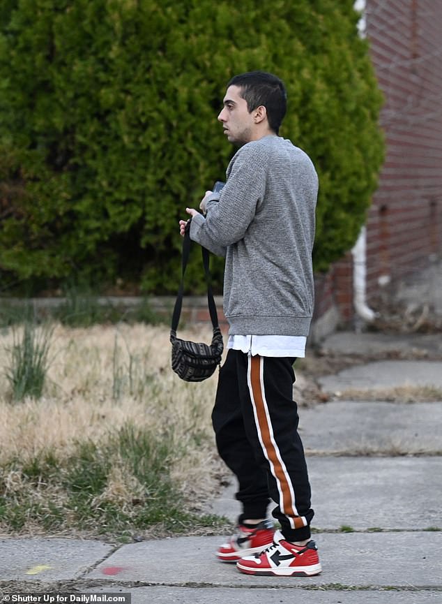 A man, believed to be squatting in the house, walks past the property on Tuesday.