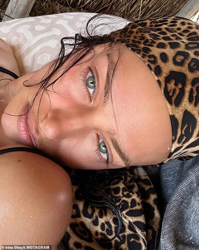 The first photo is a close-up of the beauty's face with her sparkling green eyes and a leopard print scarf on her head.