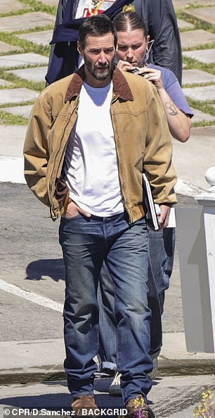 The actor looked casual in jeans and a white t-shirt with a brown jacket.
