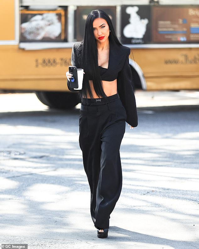 She also wore low-rise black pants and sexy Christian Louboutin heels