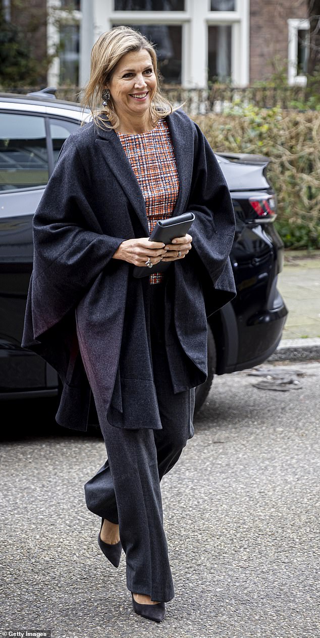 Looking typically elegant, Maxima donned a patterned orange top with gray pants and a matching cape-style blazer.