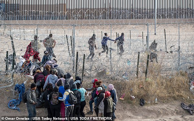 Migrants violate infrastructure set up by the Texas National Guard on the Rio Grande in El Paso, Texas, March 21, 2024.