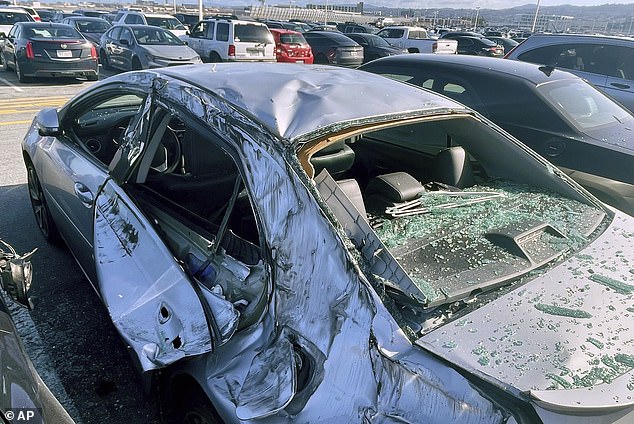 Cars can be seen smashed by the heavy wheel that fell from the United Airlines flight that left San Francisco airport heading for Osaka, Japan.