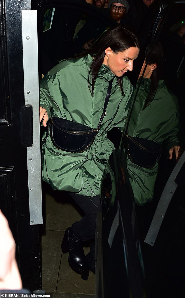 Debbie looked like she was wearing one of Liam's signature trench coats as she covered up in the green ensemble.