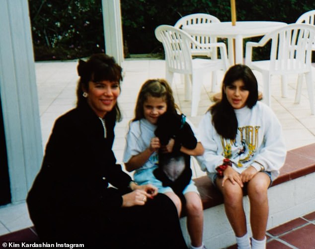 The SKIMS founder also shared a photo of herself sitting outside next to her aunt and younger sister Khloe Kardashian - who was seen cuddling a puppy in the photo.