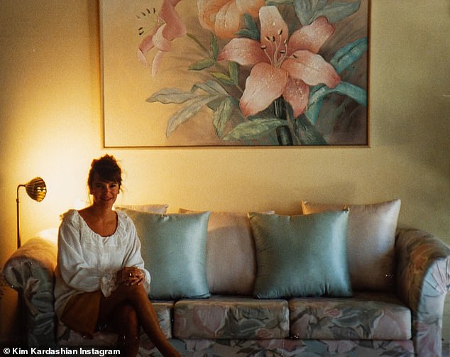 Another snap from the series showed Karen sitting on a pink and blue sofa in front of a gold floor lamp highlighting her figure.