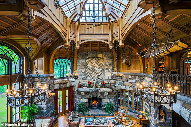The finished Lake Placid home features hand-cut stone walls, elaborate ironwork, flying buttresses, and bronze windows and doors, all the result of more than two decades of construction.