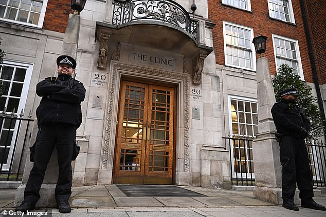 Police officers stand guard at the entrance to the London Clinic on January 17 while Kate undergoes treatment.