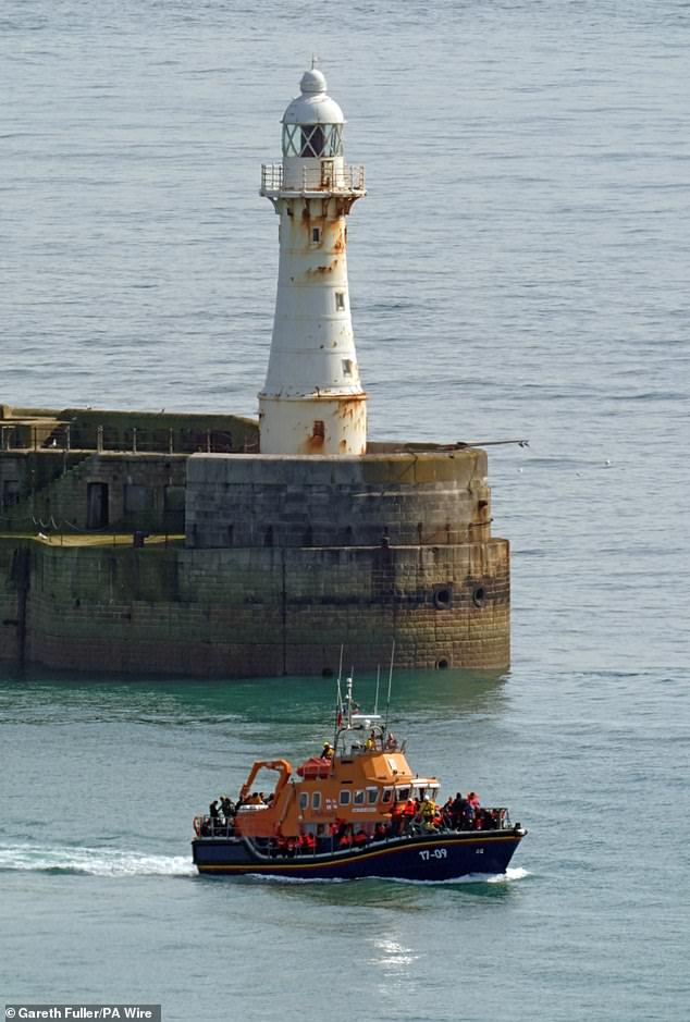 An RNLI lifeboat carrying a group of people suspected of being migrants was brought to Dover, Kent, yesterday morning.