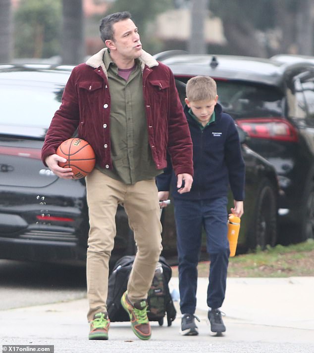 The actor and director showed off his fluff-free face while on duty with his son Samuel, 12.