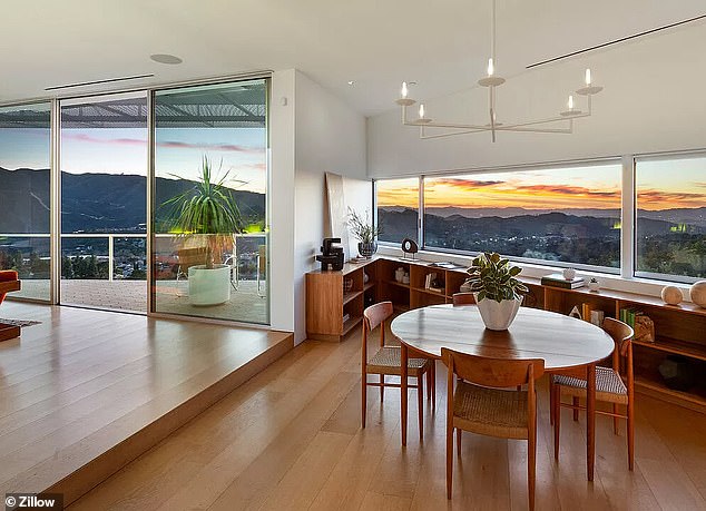 The main house has two bedrooms, two bathrooms and stunning views of the city and mountains, according to the architect's website.