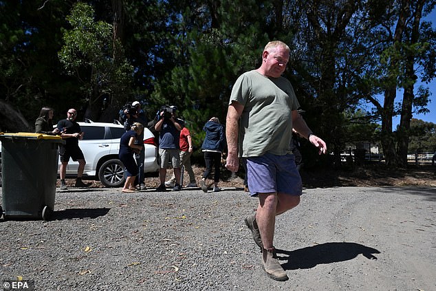 Samantha Murphy's husband Mick walks away from a group of media outside his home on March 7.  He was forced to hear updates about the police search for his wife from the same people he tried to avoid.