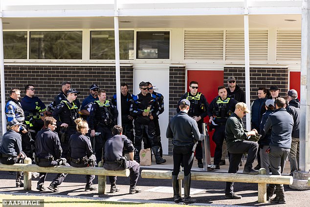 Police gather at a Buninyong reserve before heading into the bush on Wednesday