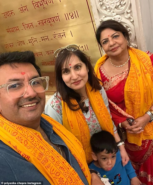 Priyanka's mother Dr Madhu Chopra accompanied them to the temple wearing a beautiful red saree.