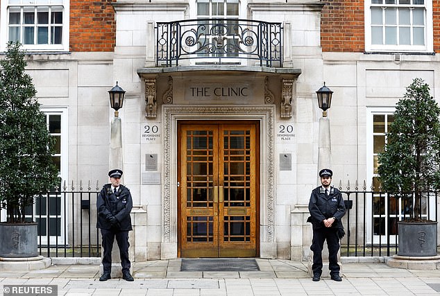 Police officers stand outside the London Clinic today, where Kate is staying after the operation.