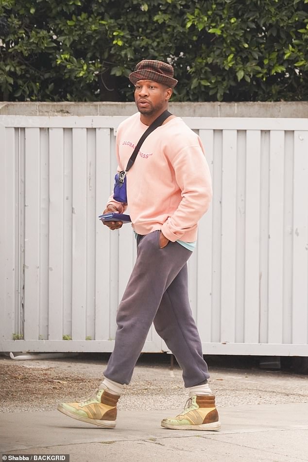 The actor, 34, was spotted out and about in Los Angeles wearing a salmon pink sweatshirt, gray sweats, worn high-top sneakers and a trendy checkered hat on his head.