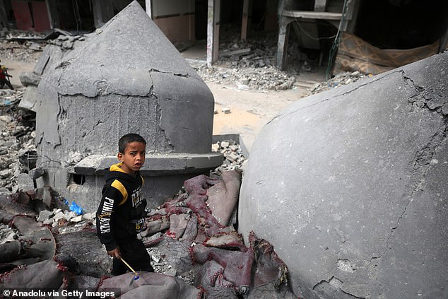 Growing hunger in Gaza raises concerns. Children play among damaged buildings around the mosque, the rubble of the Al-Farooq mosque destroyed during the Israeli attack in Rafah, Gaza, March 22, 2024.
