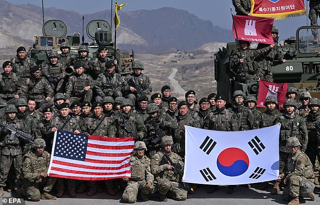 South Korean and American soldiers pose for pictures after joint exercises near the tense border with the North