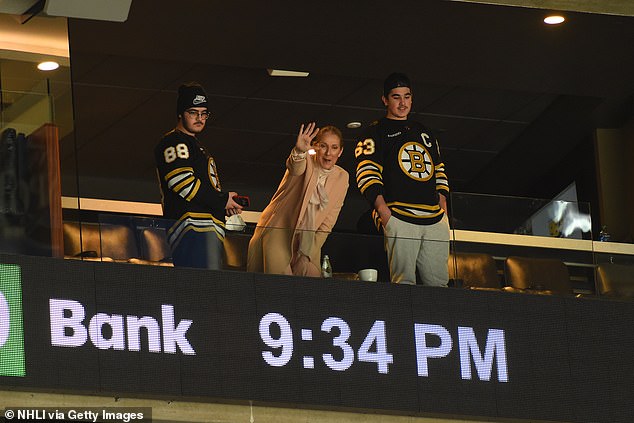 But her sons didn't seem to share her enthusiasm as they watched the Bruins get beaten 2-5 by the Rangers at TD Gardens in Boston