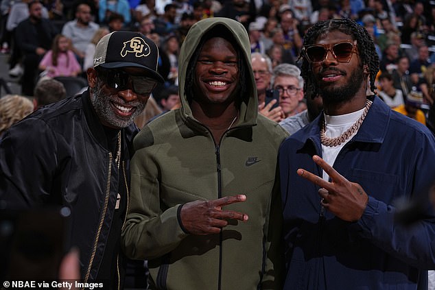 Deion Sanders, Travis Hunter and Shedeur Sanders pose before a Nuggets-Lakers game