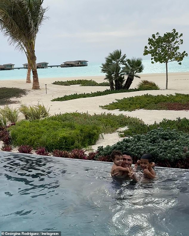 The Portuguese footballer beamed as he hugged two of his sons while enjoying a swim in a stunning infinity pool