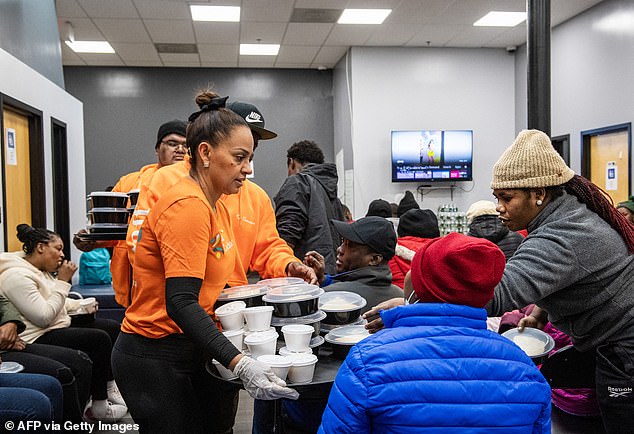 Migrants receive food distributions at a shelter in Chelsea, Massachusetts, in February 2024