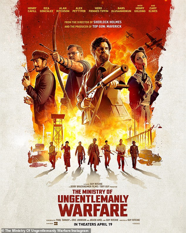 In the new poster, she is blowing a gun, far right, as she is next to many men